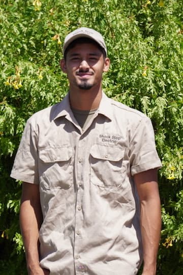 Jason Bottorff standing outside in his Shock Stop Electric work shirt